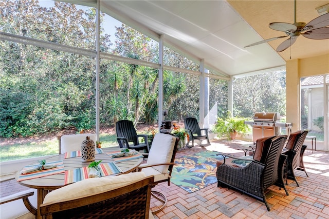 sunroom / solarium featuring ceiling fan and lofted ceiling