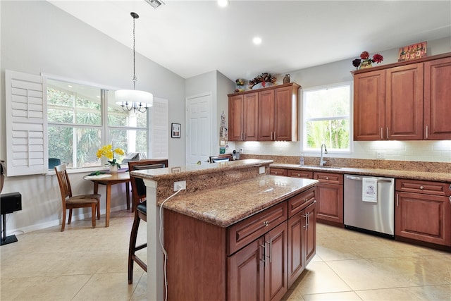 kitchen featuring a wealth of natural light, dishwasher, hanging light fixtures, and a notable chandelier