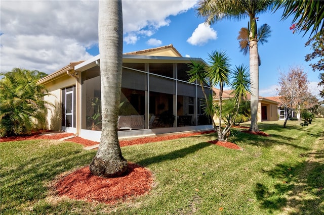 rear view of property with a lawn