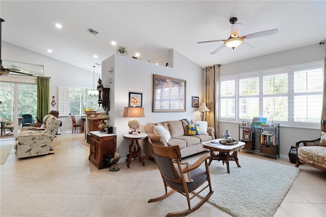 living room with ceiling fan, lofted ceiling, and light tile patterned floors