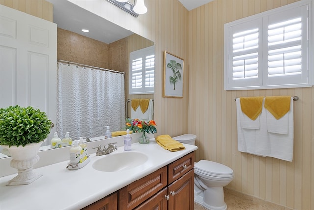 bathroom featuring a shower with curtain, vanity, a healthy amount of sunlight, and toilet