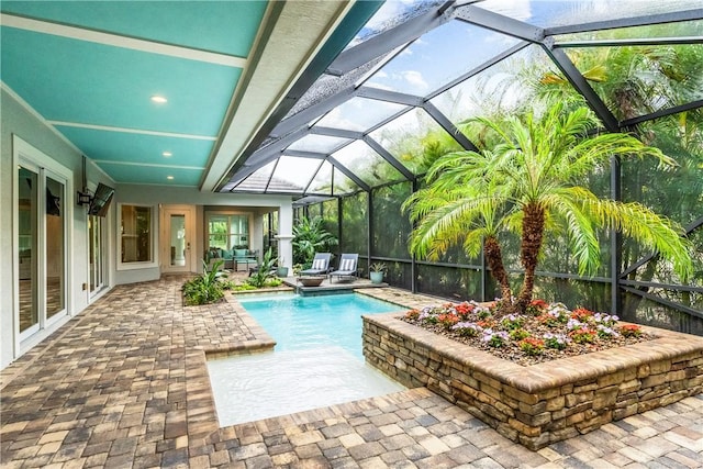 view of swimming pool with outdoor lounge area, glass enclosure, and a patio area