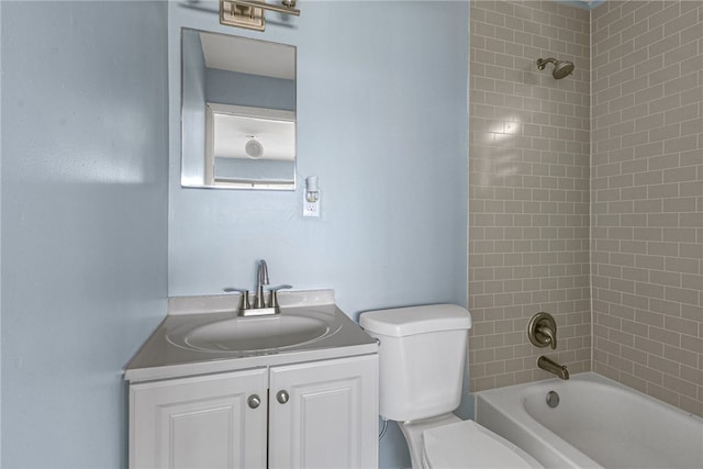 full bathroom with vanity, tiled shower / bath combo, and toilet