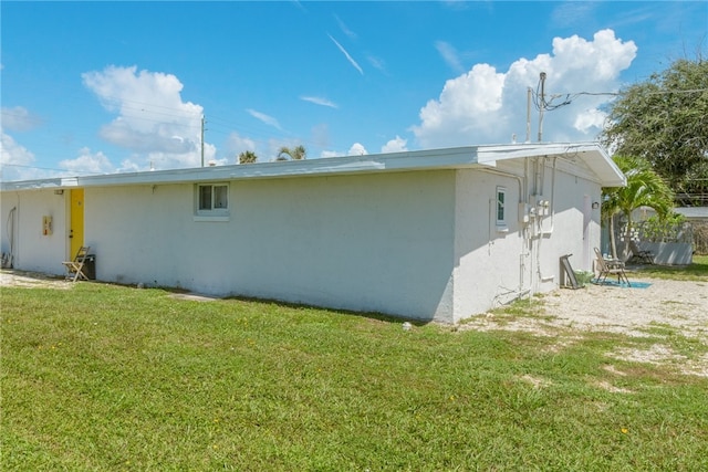 view of side of home featuring a lawn