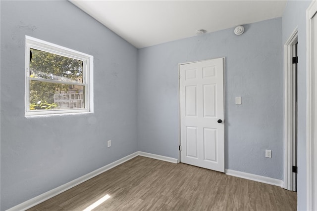 673 S Orlando Ave, Cocoa Beach, FL 32931 - unfurnished bedroom with wood finished floors and baseboards