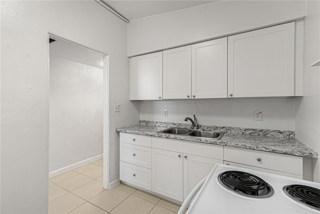 673 S Orlando Ave, Cocoa Beach, FL 32931 - kitchen featuring a sink, white electric range, white cabinets, and light tile patterned floors