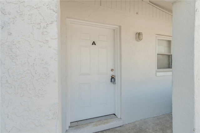 673 S Orlando Ave, Cocoa Beach, FL 32931 - property entrance with stucco siding