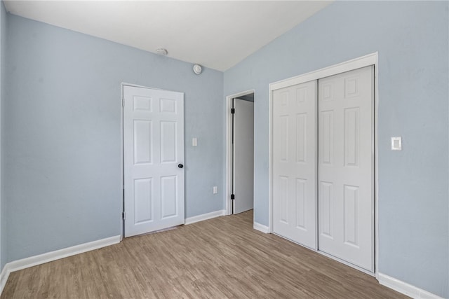 673 S Orlando Ave, Cocoa Beach, FL 32931 - unfurnished bedroom with wood finished floors, baseboards, and a closet