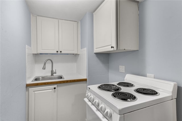 673 S Orlando Ave, Cocoa Beach, FL 32931 - kitchen with white electric range oven, a sink, white cabinets, and light countertops