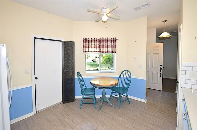 dining area featuring ceiling fan and light wood-type flooring