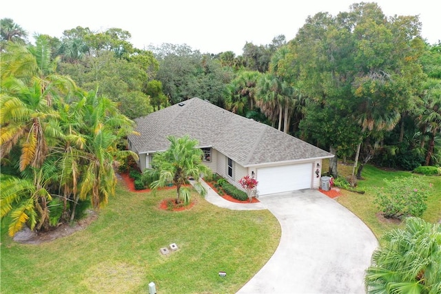 view of front of property with a front yard and a garage