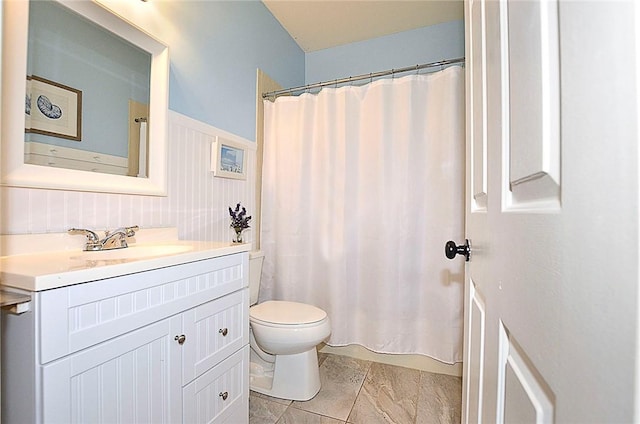 bathroom featuring vanity, a shower with shower curtain, and toilet