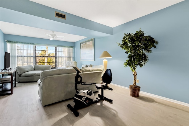 living room with ceiling fan and light hardwood / wood-style flooring