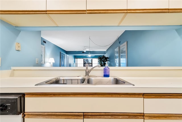 kitchen with white cabinetry and sink