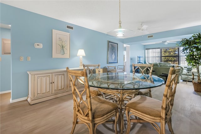 dining space featuring ceiling fan and light hardwood / wood-style flooring