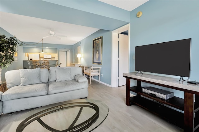 living room featuring ceiling fan and light wood-type flooring