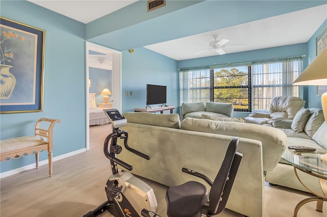 living room with light hardwood / wood-style floors and ceiling fan