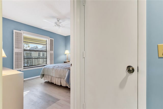 bedroom with light hardwood / wood-style floors and ceiling fan