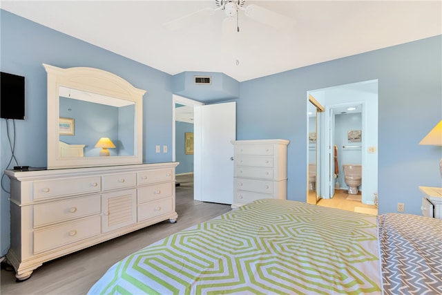 bedroom featuring ensuite bathroom, hardwood / wood-style flooring, and ceiling fan