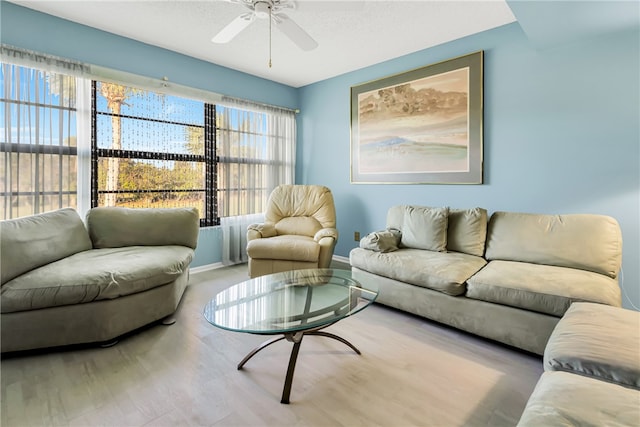 living room featuring light hardwood / wood-style floors and ceiling fan