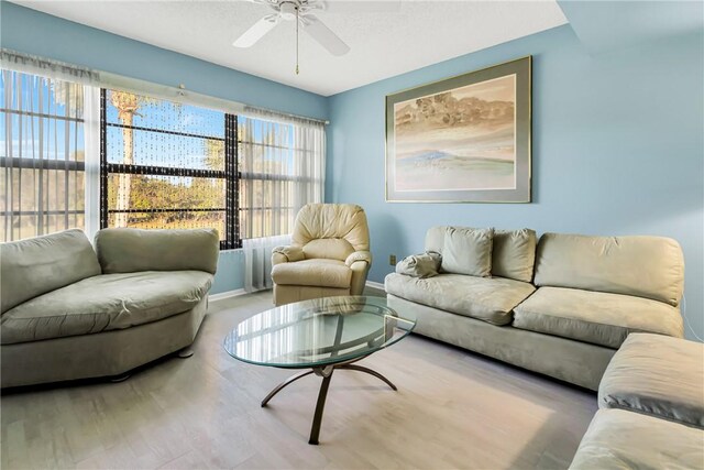 29 Plantation Dr Unit 202, Vero Beach, FL 32966 - living room with a ceiling fan, wood finished floors, and baseboards