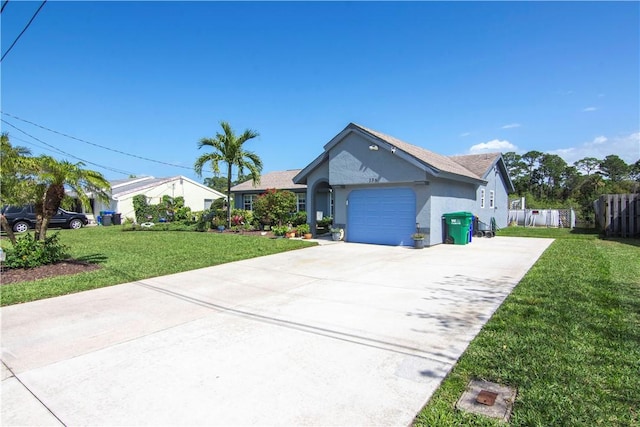 single story home featuring fence, an attached garage, stucco siding, concrete driveway, and a front lawn