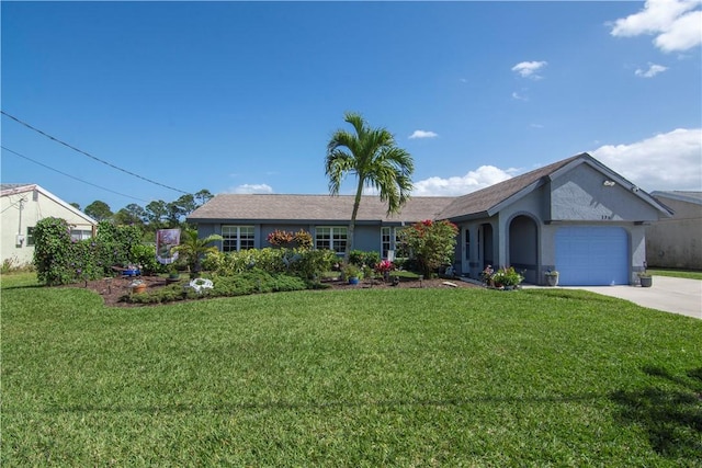 ranch-style home featuring a front lawn, an attached garage, and driveway