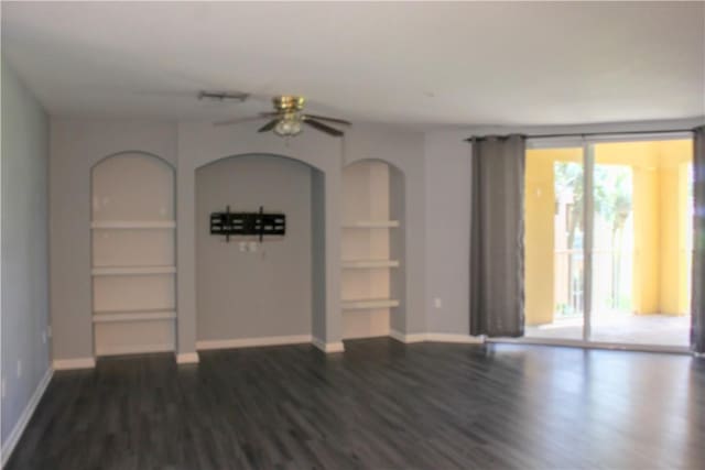 5045 Fairways Cir Unit D201, Vero Beach, FL 32967 - unfurnished living room featuring ceiling fan, dark wood finished floors, built in features, baseboards, and a wall of windows