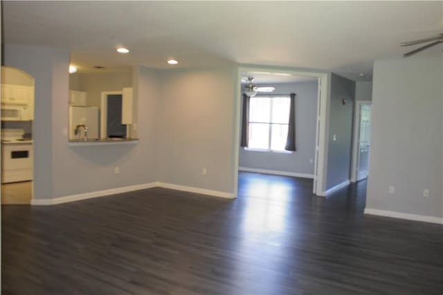 5045 Fairways Cir Unit D201, Vero Beach, FL 32967 - unfurnished living room with a ceiling fan, dark wood finished floors, recessed lighting, baseboards, and arched walkways