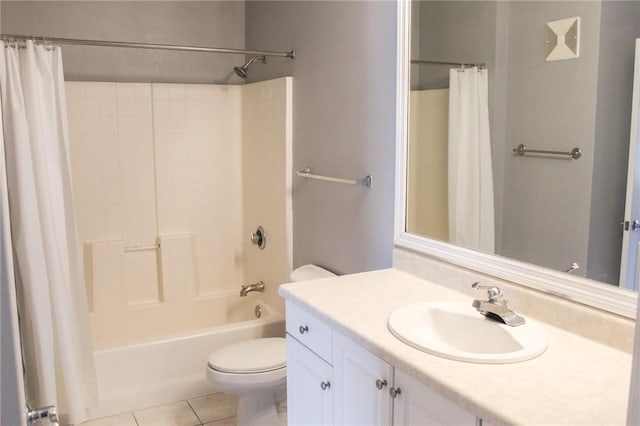 full bathroom featuring tile patterned floors, shower / bath combo with shower curtain, vanity, and toilet