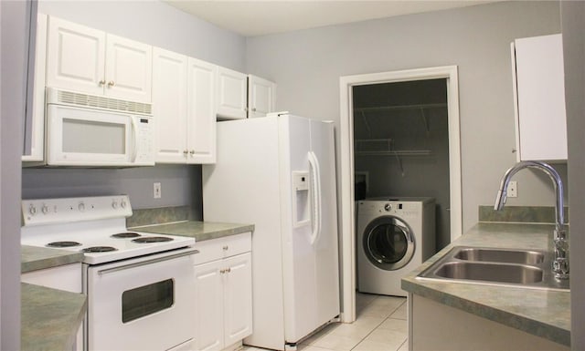 5045 Fairways Cir Unit D201, Vero Beach, FL 32967 - kitchen featuring white appliances, washer / dryer, a sink, and white cabinetry
