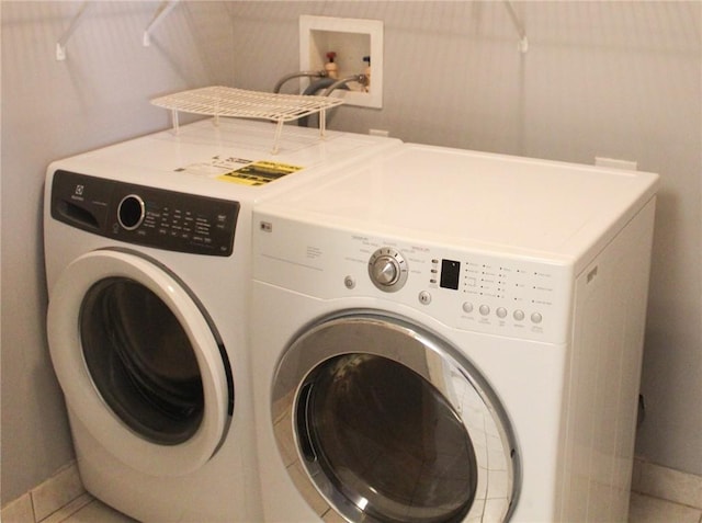 5045 Fairways Cir Unit D201, Vero Beach, FL 32967 - washroom featuring washing machine and dryer and baseboards