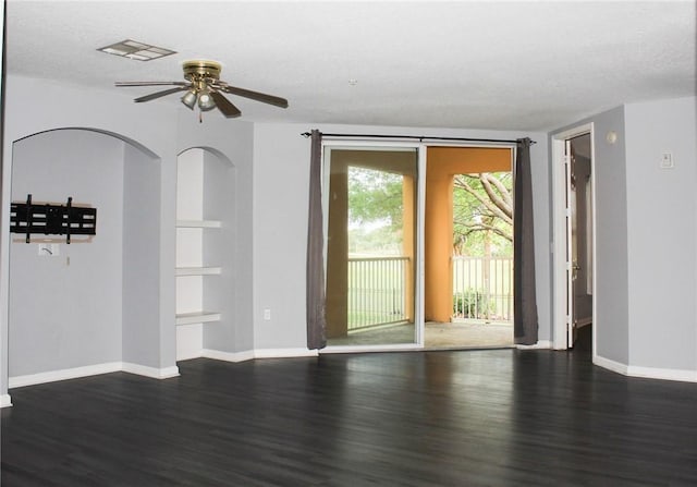 5045 Fairways Cir Unit D201, Vero Beach, FL 32967 - empty room featuring dark wood-style flooring, a ceiling fan, baseboards, and built in shelves