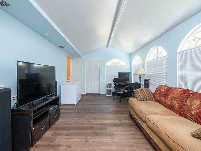 living room featuring hardwood / wood-style floors and vaulted ceiling with beams