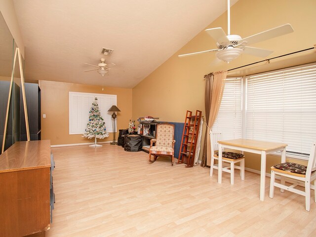 sitting room featuring ceiling fan, light wood-type flooring, and vaulted ceiling