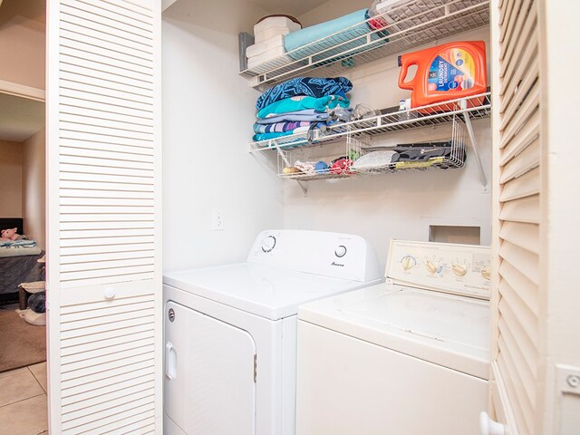 laundry room featuring light tile patterned flooring and washer and clothes dryer