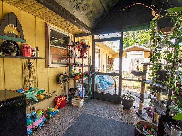 sunroom / solarium featuring vaulted ceiling