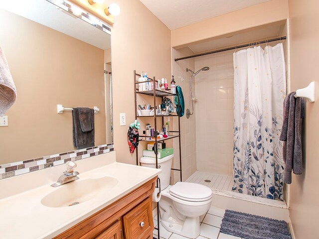 bathroom featuring walk in shower, tile patterned flooring, vanity, and toilet