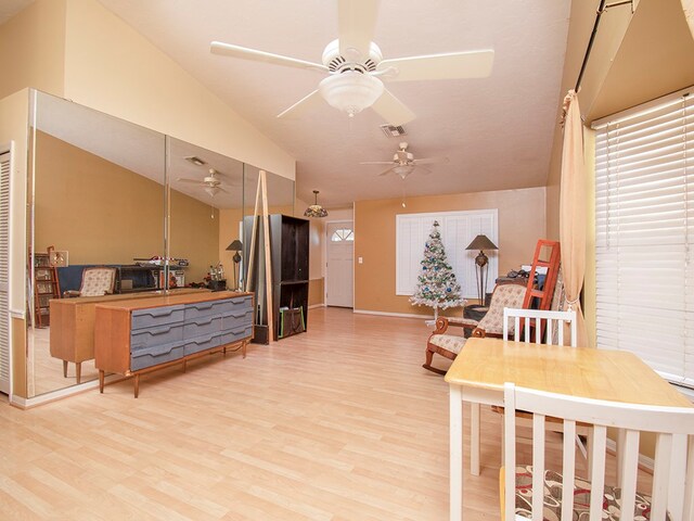 interior space featuring hardwood / wood-style flooring, ceiling fan, and lofted ceiling