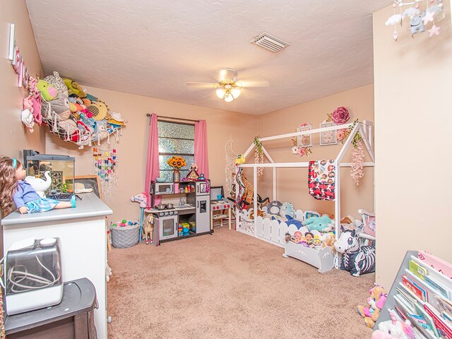 bedroom featuring a textured ceiling, carpet, and ceiling fan