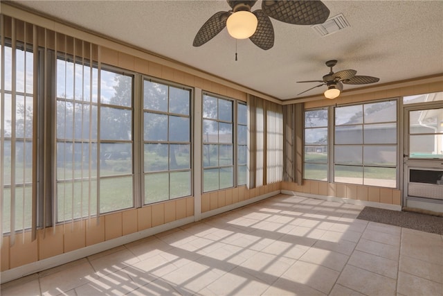 unfurnished sunroom with ceiling fan