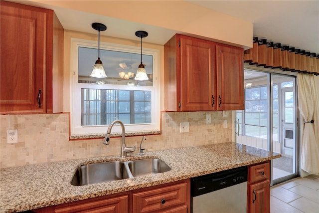 kitchen with dishwasher, light stone countertops, sink, and backsplash