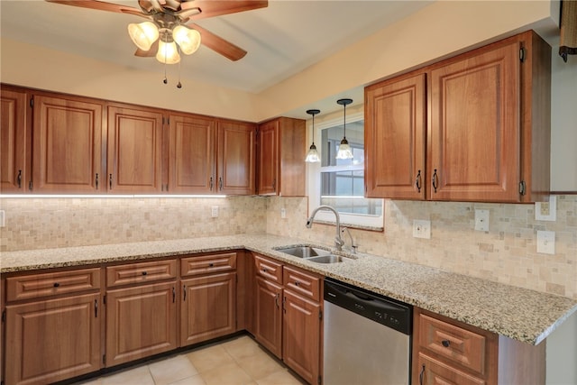 kitchen featuring stainless steel dishwasher, sink, backsplash, and light stone countertops