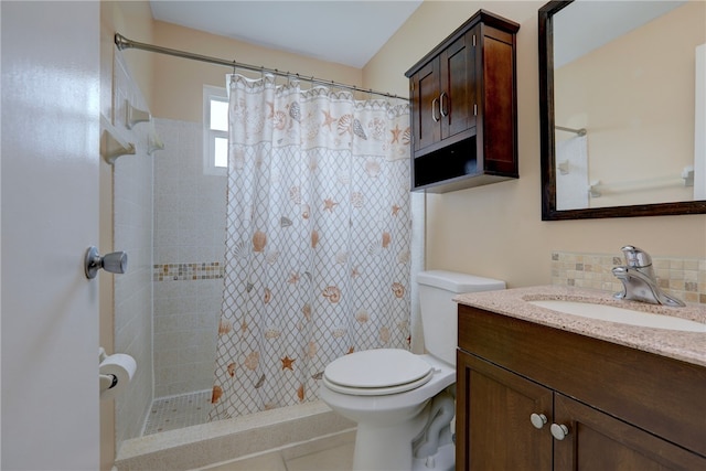 bathroom featuring tile patterned flooring, curtained shower, vanity, and toilet