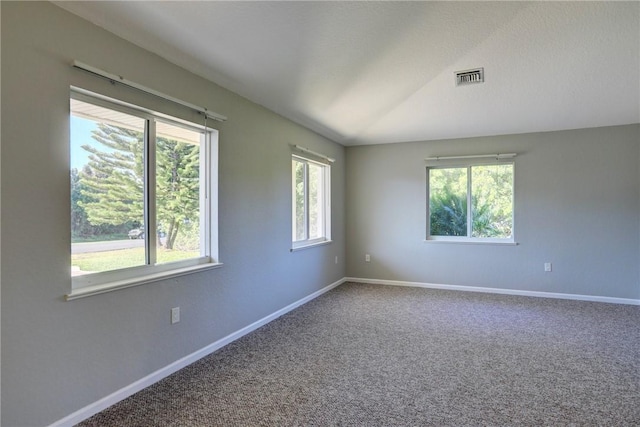 carpeted empty room with baseboards, visible vents, and a textured ceiling