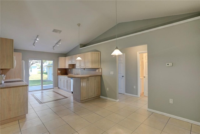 kitchen with visible vents, light tile patterned floors, decorative backsplash, baseboards, and vaulted ceiling