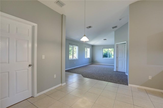 unfurnished room featuring visible vents and light tile patterned flooring