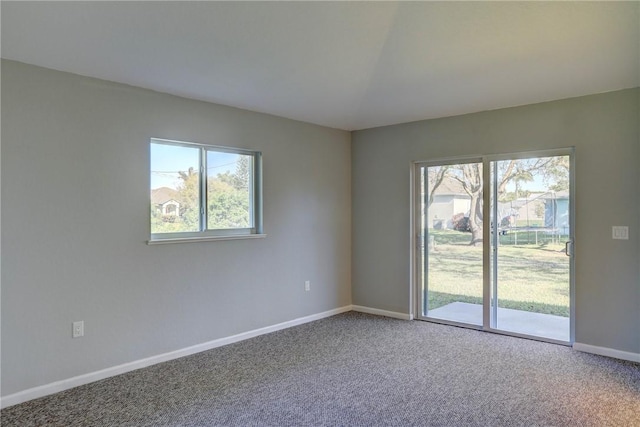 unfurnished room with carpet and baseboards