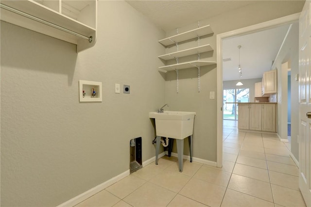 clothes washing area featuring light tile patterned floors, laundry area, hookup for an electric dryer, and washer hookup