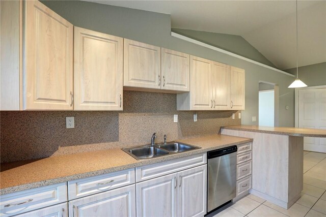 kitchen featuring stainless steel dishwasher, light countertops, light tile patterned floors, and a sink